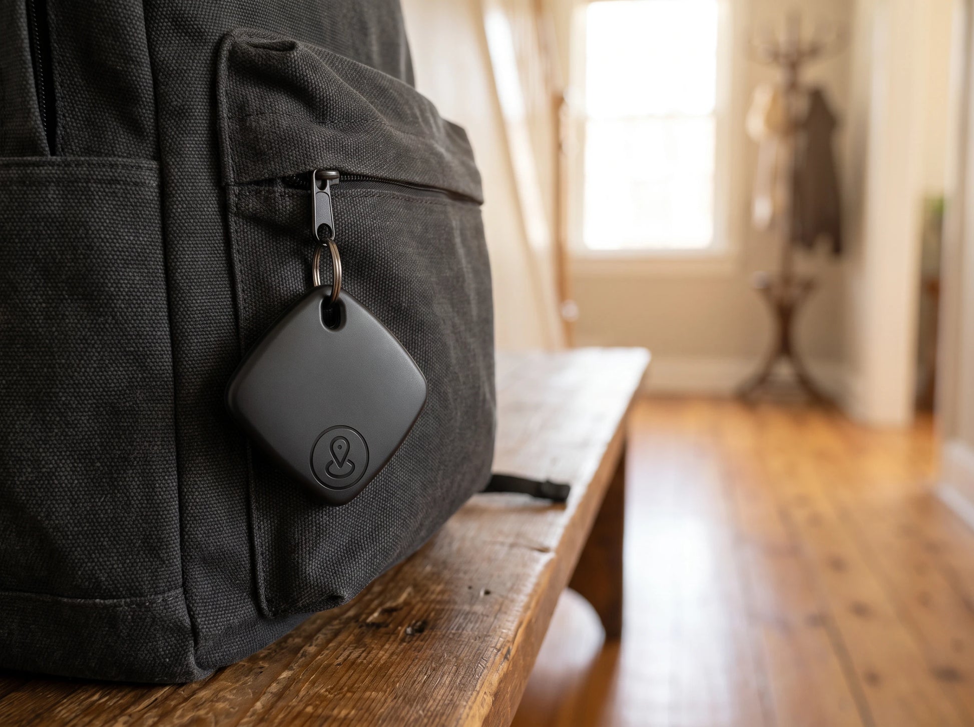 iTagPro clipped to a backpack zip
